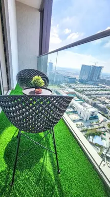 a chair on a balcony with a view of a city at STAY BY LATINEM Luxury 1BR Holiday Home CVR A2609 near Burj Khalifa in Dubai