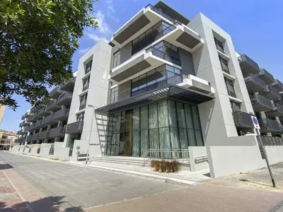 a large white building on a city street at Silkhaus Modern Studio In a Quiet Neighborhood in Dubai