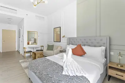 a bedroom with a bed and a living room at Silkhaus Modern Studio In a Quiet Neighborhood in Dubai