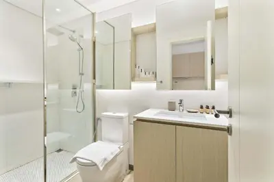 a bathroom with a toilet and a sink and a shower at Silkhaus Modern Studio In a Quiet Neighborhood in Dubai