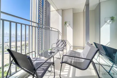 a balcony with chairs and a table on a building at Captivating 1BR at 17 Icon Bay Dubai Creek Harbour by Deluxe Holiday Homes in Dubai