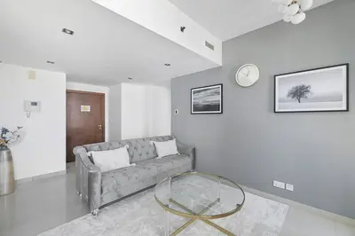 a living room with a couch and a glass table at StoneTree - Park Island Blakely 1 BR - Prime location in Dubai