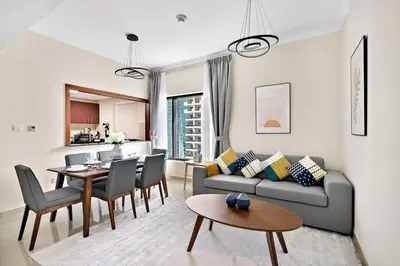 a living room with a couch and a table at StoneTree - Time Place Tower 1 BR - Amazing View in Dubai
