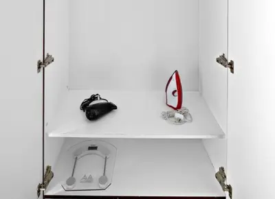 a white cabinet with two shelves with a purse on it at StoneTree - Time Place Tower 1 BR - Amazing View in Dubai