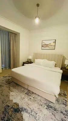 a bedroom with a large white bed and a window at AMAKIN Burj Vista Tower 1 in Dubai