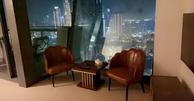 a room with two chairs and a table and a window at AMAKIN Burj Vista Tower 1 in Dubai