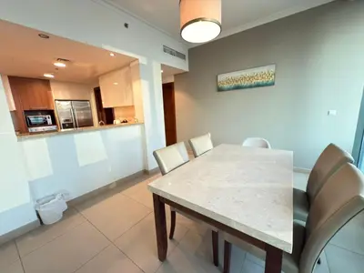 a kitchen and dining room with a table and chairs at AMAKIN Burj Vista Tower 1 in Dubai