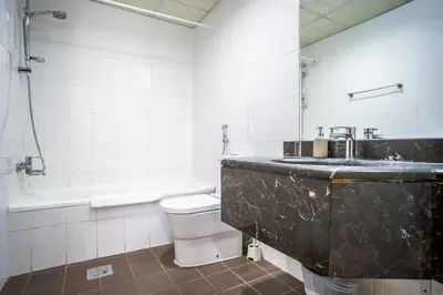 a bathroom with a sink and a toilet and a tub at RH- City Center Retreat,1BR, walk to Burj Khalifa in Dubai