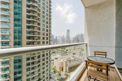a balcony with a bench and a view of a city at RH- City Center Retreat,1BR, walk to Burj Khalifa in Dubai