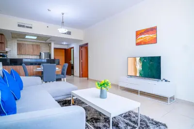 a living room with a couch and a tv at RH- City Center Retreat,1BR, walk to Burj Khalifa in Dubai
