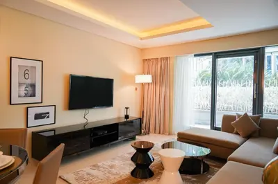 a living room with a couch and a flat screen tv at Luton Vacation Homes - Damac Tower By Paramount - Business Bay, Dubai - 80AB4 in Dubai