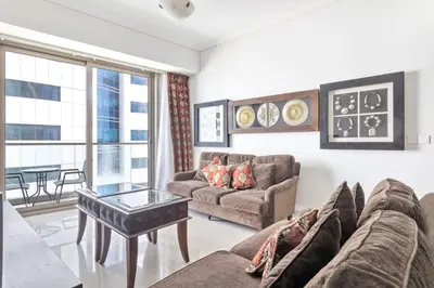 a living room with a couch and a table at StoneTree - Ocean Heights 1 BR - High Floor in Dubai