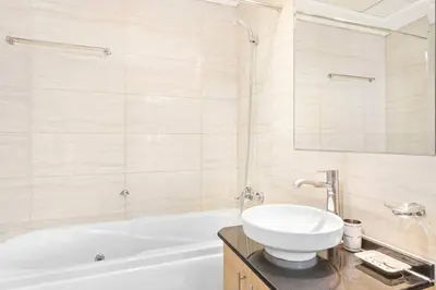 a bathroom with a white tub and a sink at StoneTree - Ocean Heights 1 BR - High Floor in Dubai