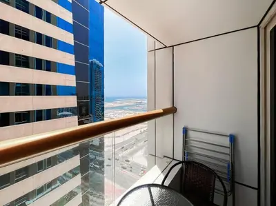 a balcony with a view of a city from a building at StoneTree - Elite Residence 1 BR - Near Dubai Tram in Dubai