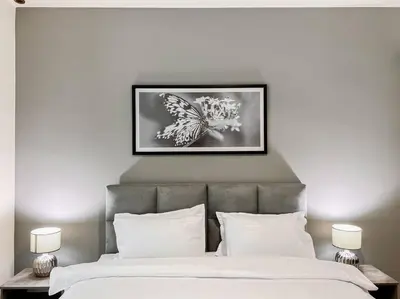 a bed with two white pillows and a picture above it at StoneTree - Elite Residence 1 BR - Near Dubai Tram in Dubai