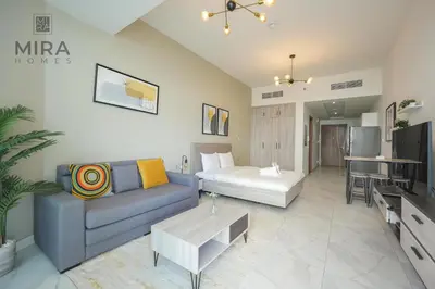 a living room with a couch and a table at Mira Holiday Homes - Fully furnished Studio in Business Bay in Dubai