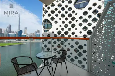 a table and chairs on a balcony with a view of the city at Mira Holiday Homes - Fully furnished Studio in Business Bay in Dubai