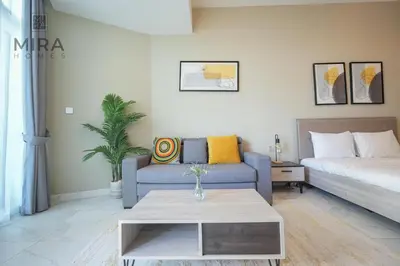 a living room with a couch and a coffee table at Mira Holiday Homes - Fully furnished Studio in Business Bay in Dubai
