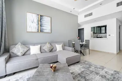 a living room with a couch and a table at StoneTree - SkyView Tower 1 BR - Best Location in Dubai