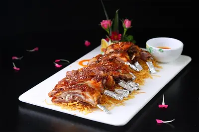 a plate of food with meat on top of rice at Peony Hotel in Dubai