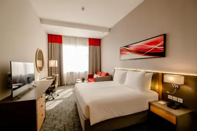 a hotel room with a bed and a television at Peony Hotel in Dubai