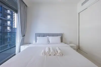 a bedroom with a bed with two towels on it at Sea View with Private Beach Access! 3BR & Maid Rm in Dubai