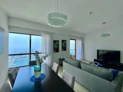 a living room with a couch and a table at JBR Beach - Panoramic Sea View 2BR Apartment in Dubai