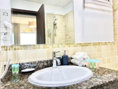 a bathroom counter with a sink and a mirror at JBR Beach - Panoramic Sea View 2BR Apartment in Dubai