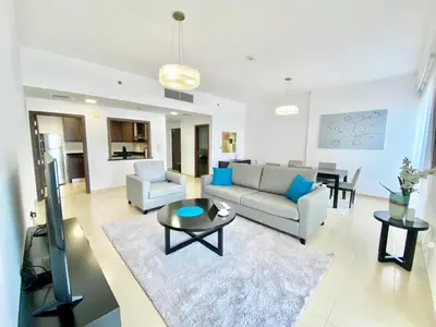a living room with a couch and a table at JBR Beach - Panoramic Sea View 2BR Apartment in Dubai