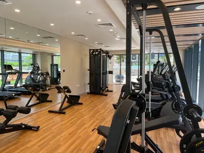 a gym with several treadmills and elliptical machines at Business Bay 1 bedroom with Canal view in Dubai