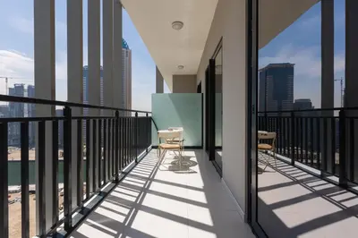 a balcony with chairs and a view of the city at Business Bay 1 bedroom with Canal view in Dubai