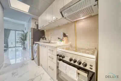 a kitchen with a stove and a sink at Classic 1BR at MAG 510 Dubai South by Deluxe Holiday Homes in Dubai