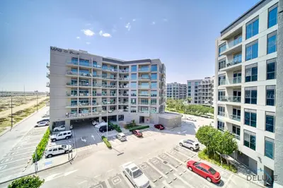 an overhead view of a parking lot with two tall buildings at Classic 1BR at MAG 510 Dubai South by Deluxe Holiday Homes in Dubai