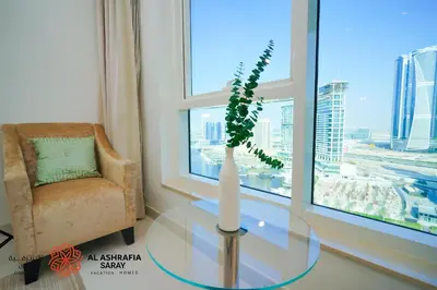 a room with a glass table with a vase on it at Alashrafia Saray - Spectacular 2BR in Canal Views in Dubai