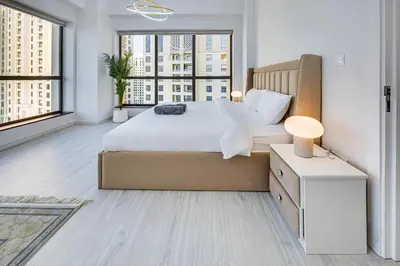 a bedroom with a large bed and large windows at JBR 3 bedroom apartment with fantastic ocean view in Dubai