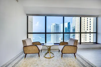 a room with a table and chairs and a large window at JBR 3 bedroom apartment with fantastic ocean view in Dubai