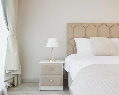 a bedroom with a bed and a nightstand with a lamp at 1 bedroom in Torch Tower Dubai Marina in Dubai