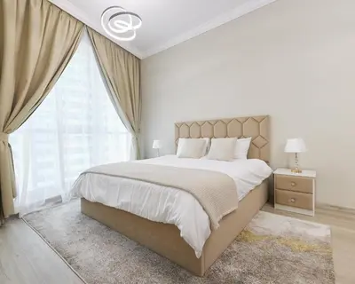 a white bedroom with a large bed and a window at 1 bedroom in Torch Tower Dubai Marina in Dubai