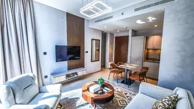 a living room with a couch and a table at STAY BY LATINEM Luxury 1BR Holiday Home CVR A3002 near Burj Khalifa in Dubai