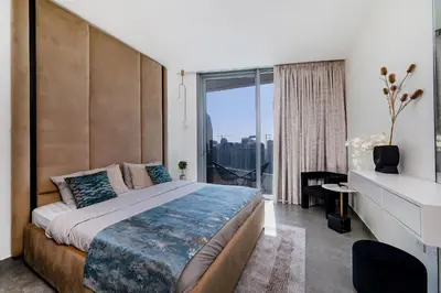a bedroom with a large bed with a large window at Luxury Residence Stella Maris in Dubai