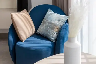 a blue chair with pillows on it next to a table at Luxury Residence Stella Maris in Dubai
