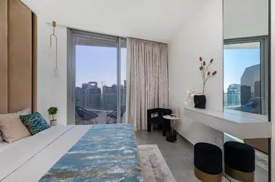 a bedroom with a large bed and a large window at Luxury Residence Stella Maris in Dubai