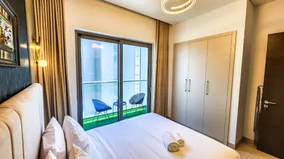 a bedroom with a bed and a large window at STAY BY LATINEM Luxury 1BR Holiday Home CVR A3001 near Burj Khalifa in Dubai