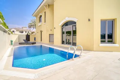 a swimming pool in the backyard of a house at Frond E Villa, Palm Jumeirah - Mint Stay in Dubai
