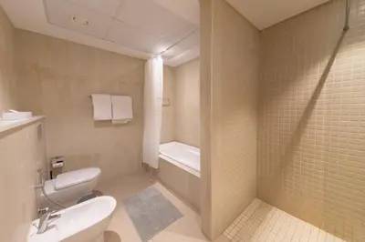 a bathroom with a toilet and a bath tub at Al Bateen Residences, Jumeirah Beach Residence - Mint Stay in Dubai