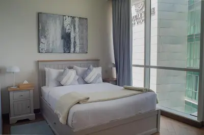 a bedroom with a large bed and a window at Al Bateen Residences, Jumeirah Beach Residence - Mint Stay in Dubai