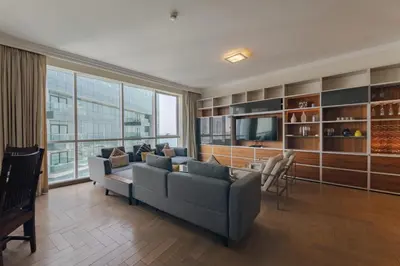 a living room with a couch and a tv at Al Bateen Residences, Jumeirah Beach Residence - Mint Stay in Dubai