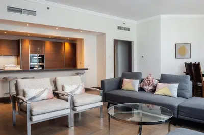 a living room with a couch and chairs and a table at Al Bateen Residences, Jumeirah Beach Residence - Mint Stay in Dubai