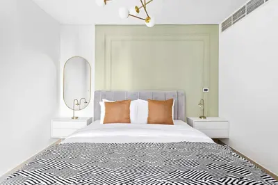 a bedroom with a large bed and two night stands at Silkhaus with Burj Khalifa view1BDR with modern amenities in Dubai