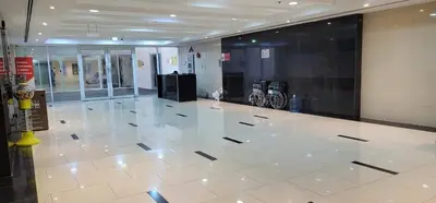 a lobby with a large white tile floor in a building at Sea View Apartments Marina with Party Hall in Dubai
